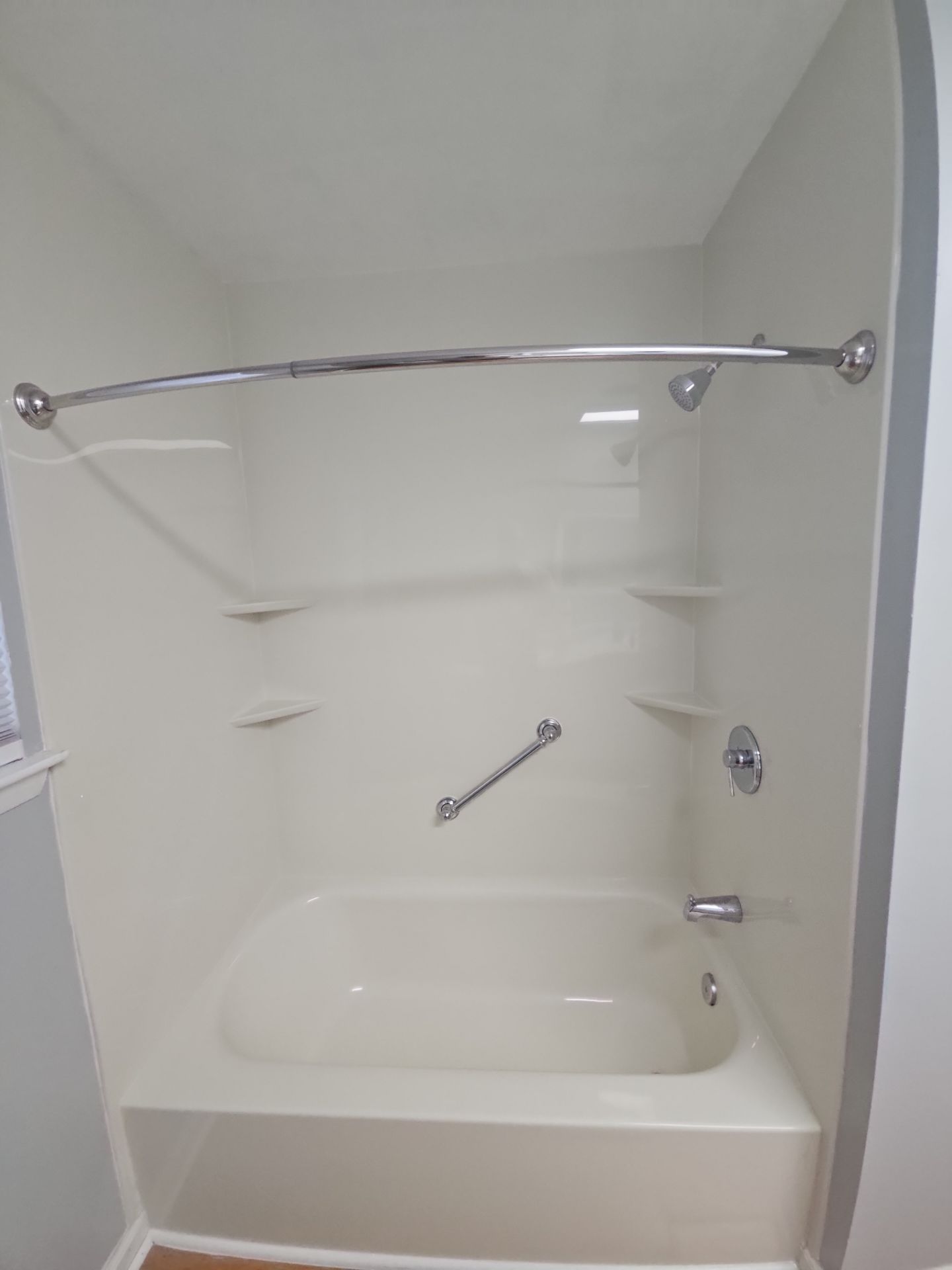 http://Shower%20to%20tub%20conversion%20with%20white%20walls.%20shelves,%20and%20grab%20bar%20with%20a%20curtain%20rod